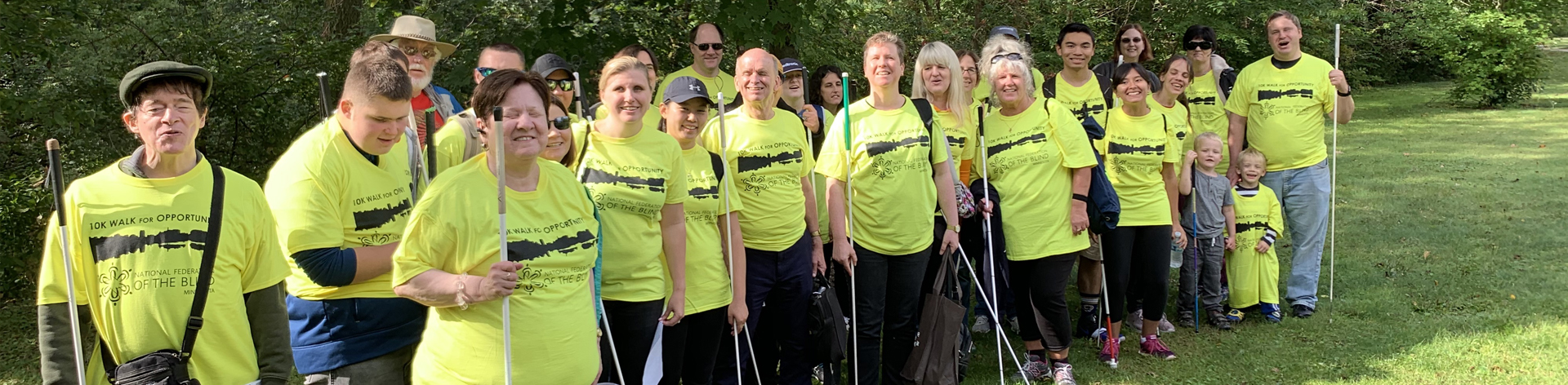 NFB of Minnesota members smile together for a photograph before they start thier 10K walk for opportunity.