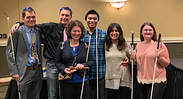A group of blind students smile together